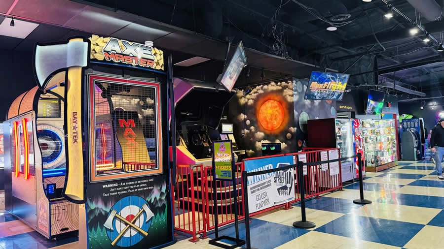 Axe Master arcade game next to MaxFlight flight simulator and space mural